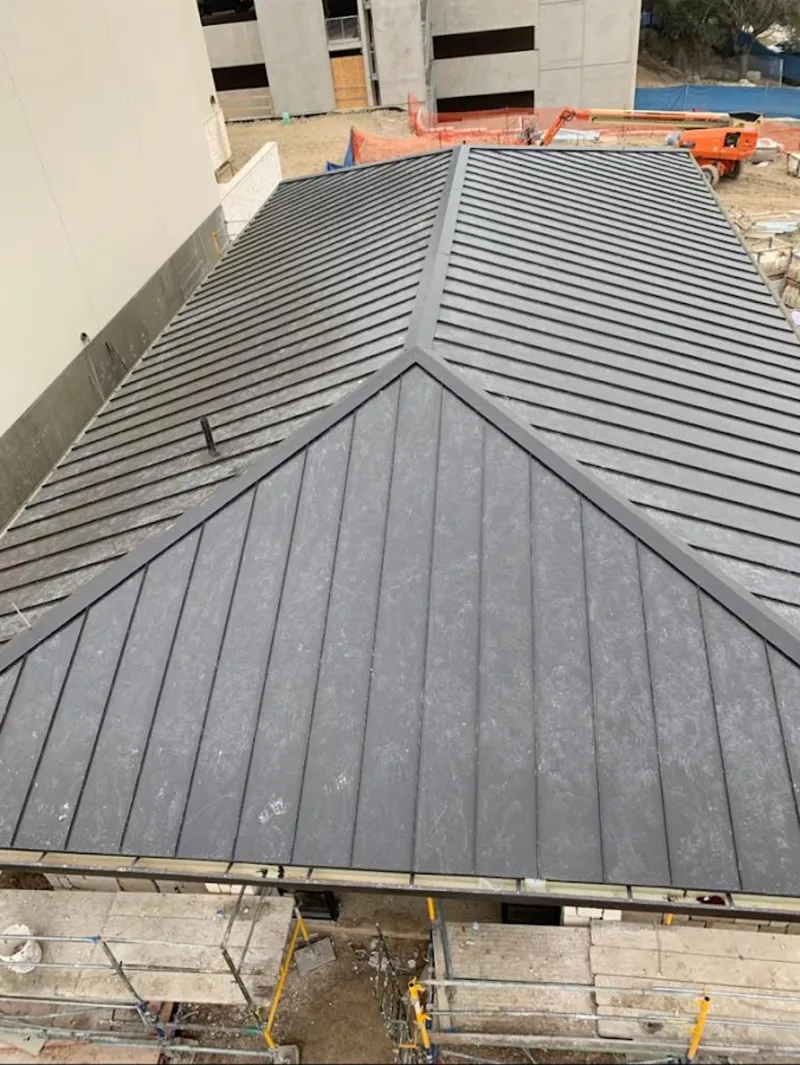 Commercial metal roof construction with crane equipment in Temple City